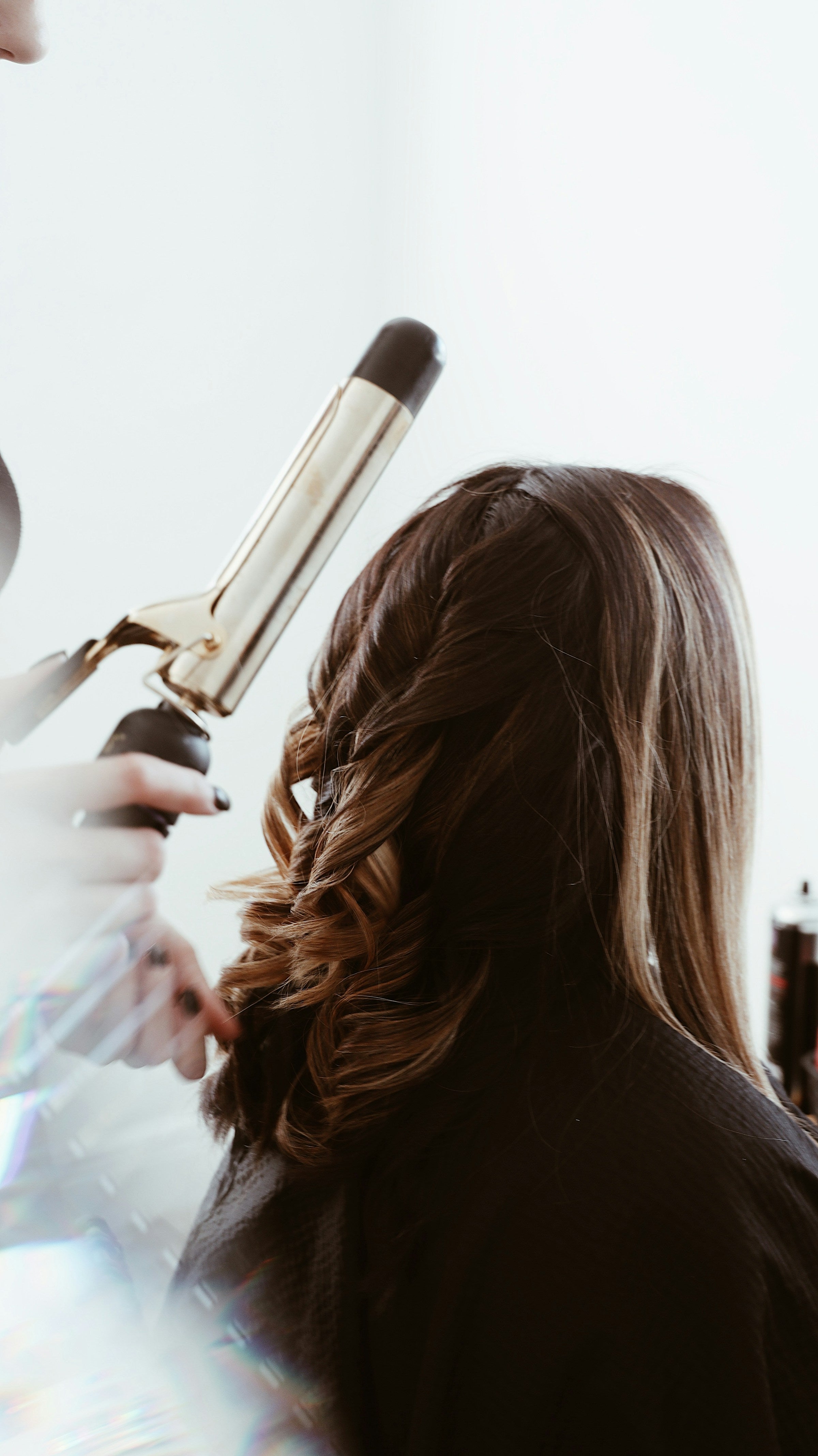 Long brunette balayage being styled — Ukiyo Hair Extensions