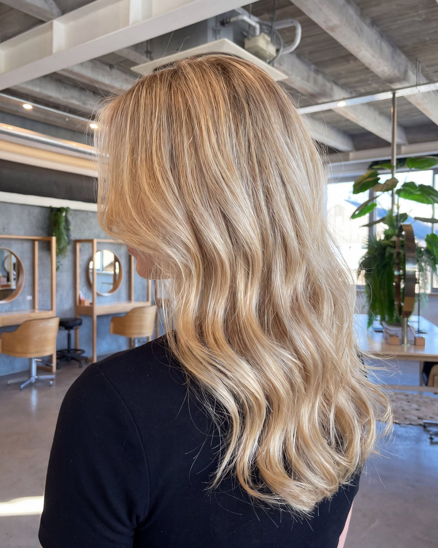 Bright even blonde lightening on long layers