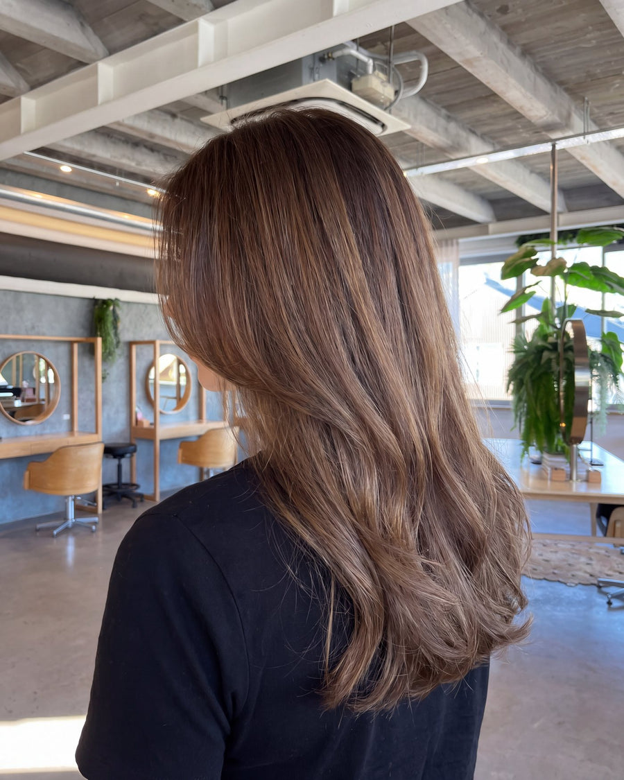 Glossy even brunette global colour on long hair